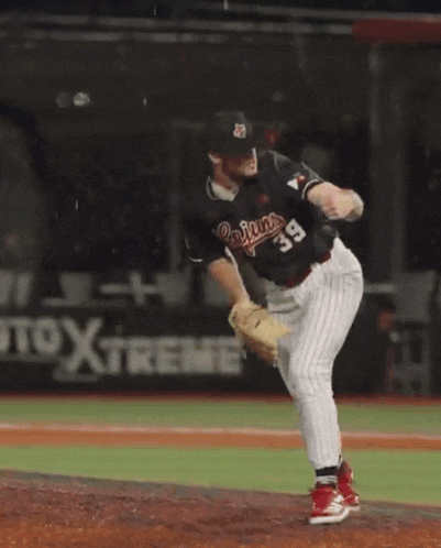 a baseball player wearing a cajuns jersey stands on the field