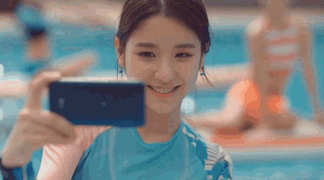 a woman taking a picture of herself with her phone