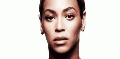a close up of a woman 's face with a serious look on her face on a white background .