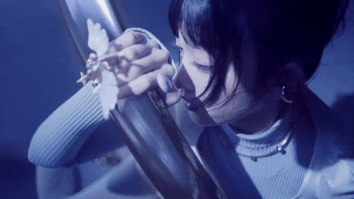 a woman is holding a butterfly in her hand
