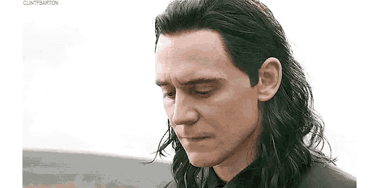 loki from avengers : age of ultron is looking down with a sad look on his face .