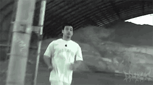 a man in a white shirt with an apple logo on it is running .