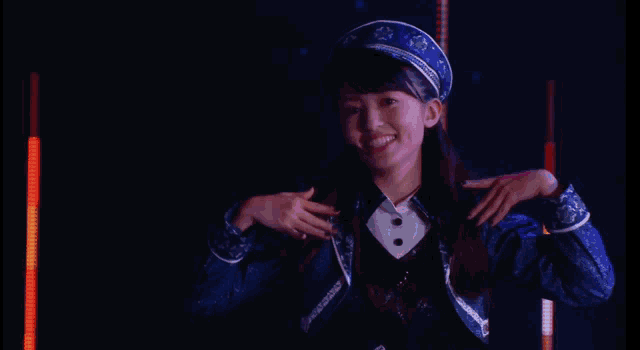 a woman wearing a blue hat with a microphone on her head