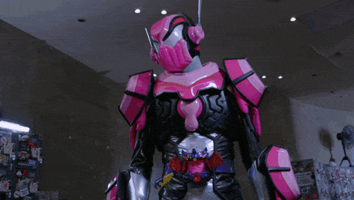 a robot in a pink and black suit is holding a purple object
