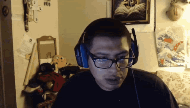 a man wearing glasses and headphones is looking at something