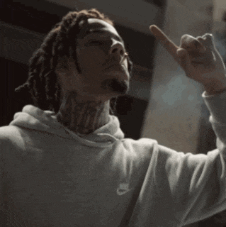 a man with dreadlocks and a tattoo on his neck is wearing a nike hoodie