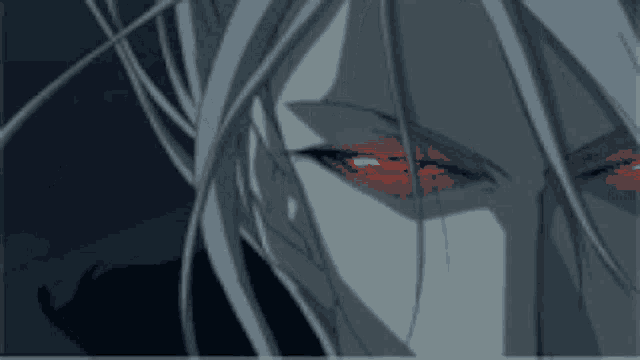 a close up of a person 's face with red eyes .