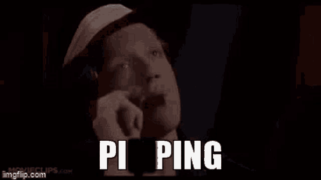 a man in a hat is talking on a cell phone with the words `` pi ping '' written above him .