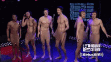 a group of naked men are standing on a stage in front of a siriusxm logo
