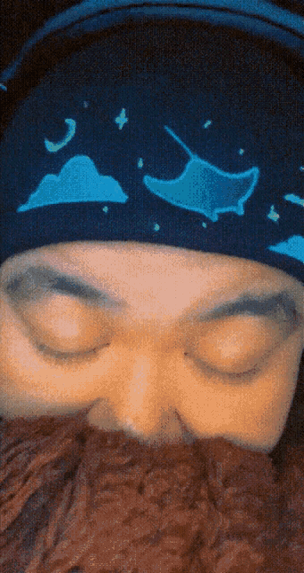 a close up of a person 's face with a beanie on