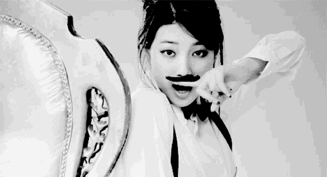 a black and white photo of a woman in a bow tie