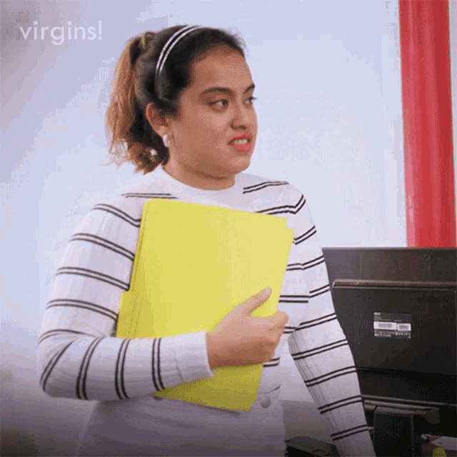 a woman in a striped shirt is holding a yellow folder and says virgins on the bottom