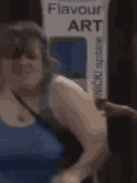 a woman standing in front of a sign that says flavour art