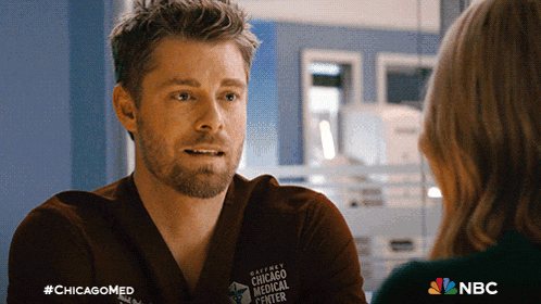 a man in a scrub is talking to a woman in a chicago medical center ad