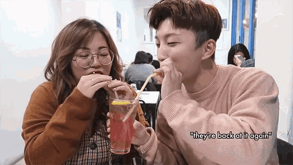 Theyre Back At It Again Couple GIF - Theyre Back At It Again Couple Share Drink GIFs