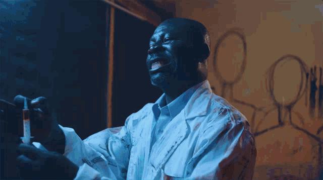 a man in a lab coat is holding a syringe and smiling