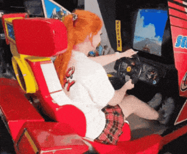 a woman is playing a video game with the word sega on the side