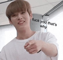 a young man in a white shirt is pointing at the camera with the words " fuck you that 's why " written on his shirt