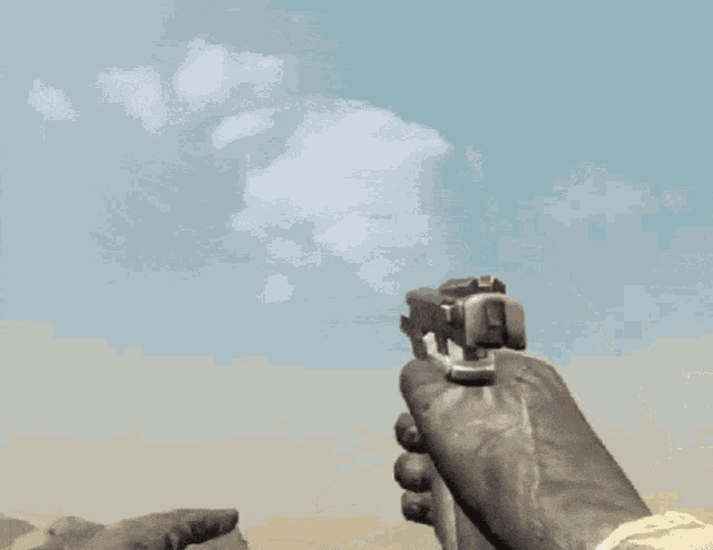 a person holding a gun with a cloud in the sky behind them