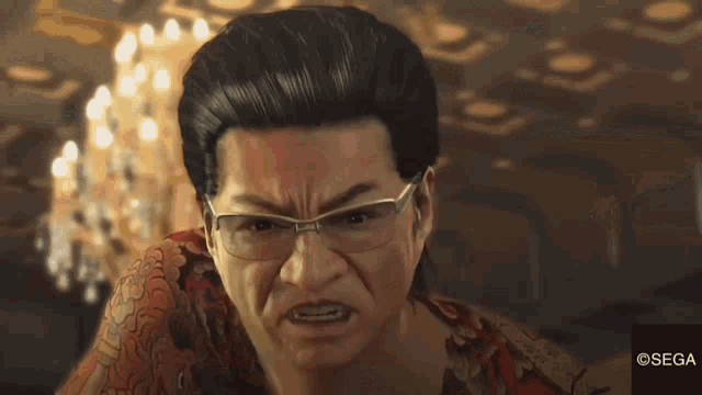 a man wearing glasses and a red shirt has a sega logo on the bottom
