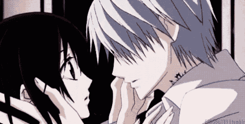 a man and a woman are kissing each other in a dark room .