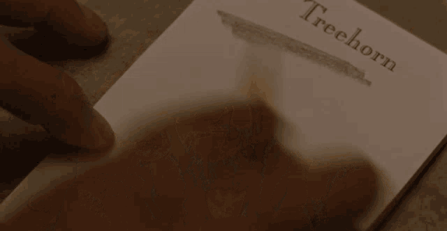 someone is holding a piece of paper that says treehorn on it