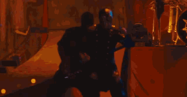 a man playing a guitar and another man playing drums
