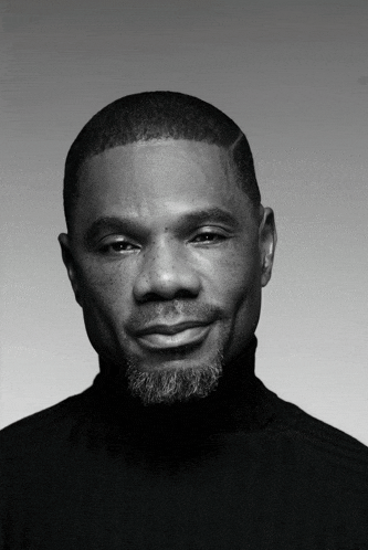 a man with a beard wearing a black turtleneck
