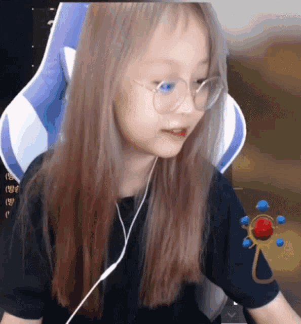 a little girl wearing glasses and headphones is sitting in a gaming chair