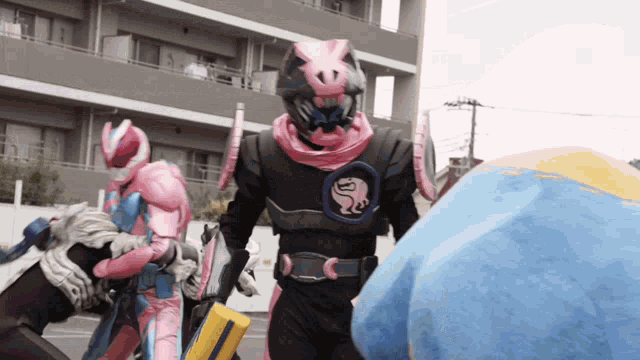 a man in a pink and black costume with a lion on his chest