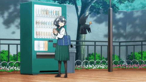 a girl stands in front of a vending machine holding a cup of coffee