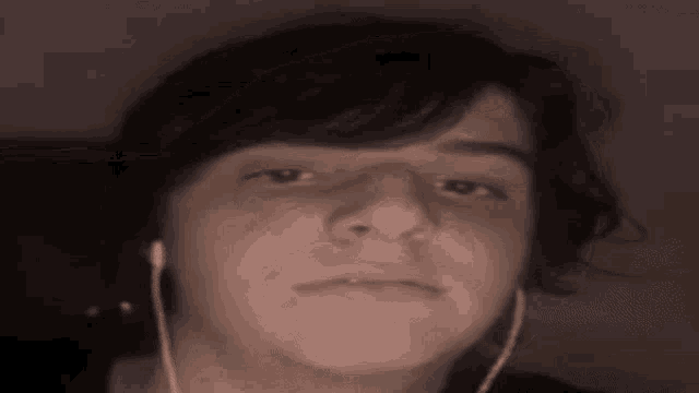 a close up of a person 's face with headphones on