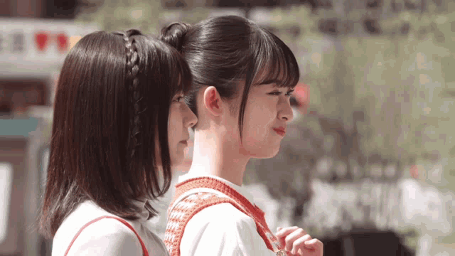 two girls are standing next to each other and one has a braided headband