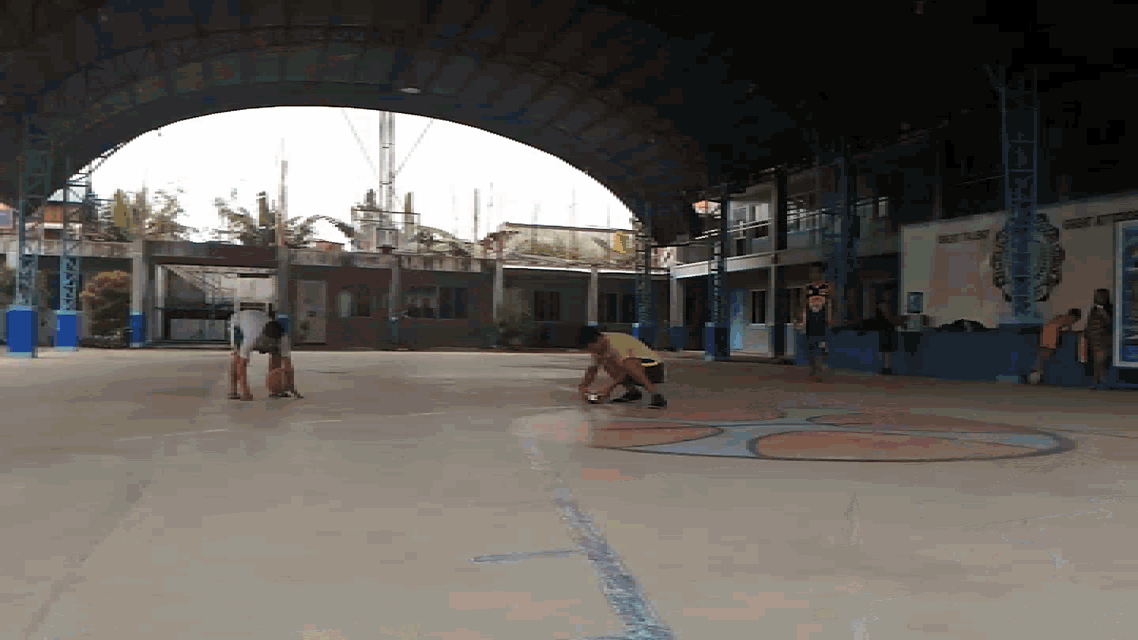 a group of people are playing basketball in a court with a sign that says ' universidad de santo tomas ' on it