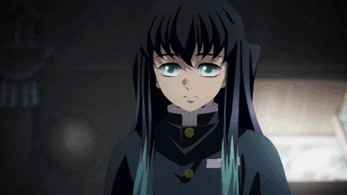 a girl with long black hair and blue streaks looks at the camera