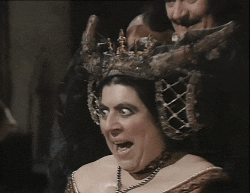 a close up of a woman 's face with a very strange look on her face