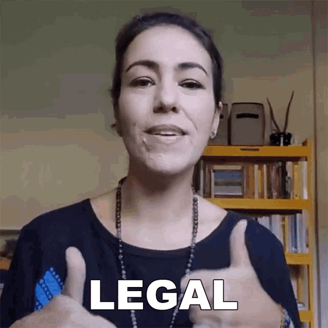 a woman is giving a thumbs up and the word legal is on her face
