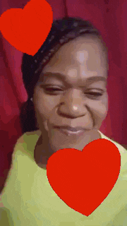 a woman with two red hearts on her head is smiling