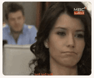 a man and a woman are sitting in front of a screen that says mbc on it