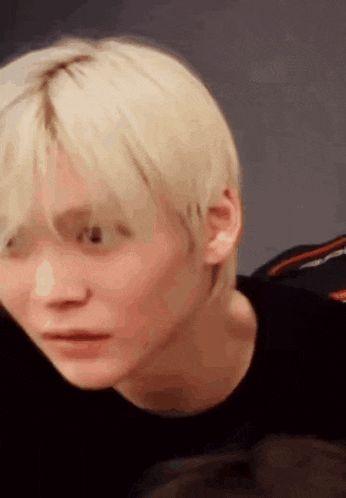 a close up of a person 's face with blonde hair .
