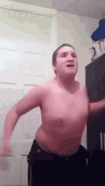 a man without a shirt is dancing in a room .