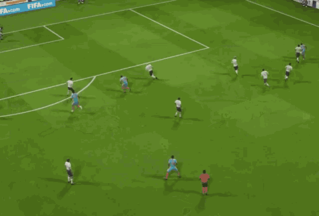 a soccer game is being played in front of a banner that says fifa