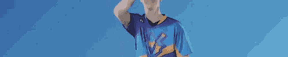 a person is wearing a blue and yellow jersey with a basketball player on it .