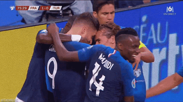 a group of soccer players hugging each other with the number 9 on the back