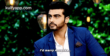 a man in a blue suit says i 'd marry anushka