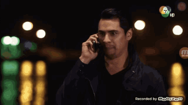 a man is talking on a cell phone with a watermark that says recorded by mobizen