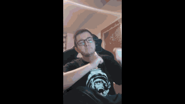 a man wearing a black shirt with a monkey on it