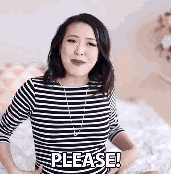 a woman in a striped shirt is sitting on a bed with her hands on her hips and says please