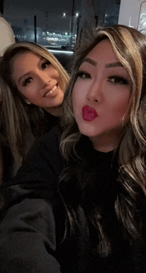 two women are posing for a picture together and one has red lips