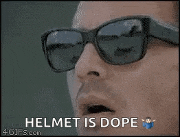 a man wearing sunglasses and a helmet is dope